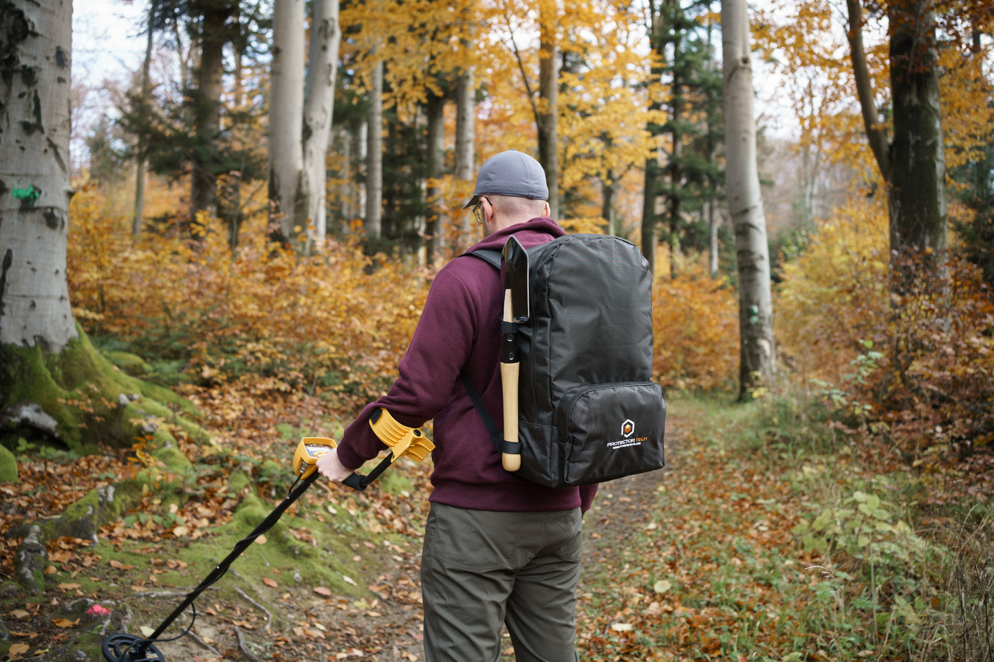 A backpack for a metal detector with a shovel attachment